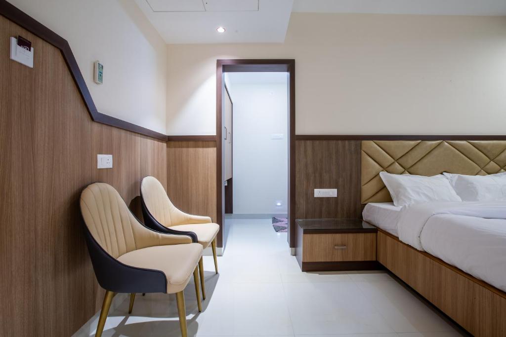 Postel nebo postele na pokoji v ubytování Hotel PRM Aruna Archadia