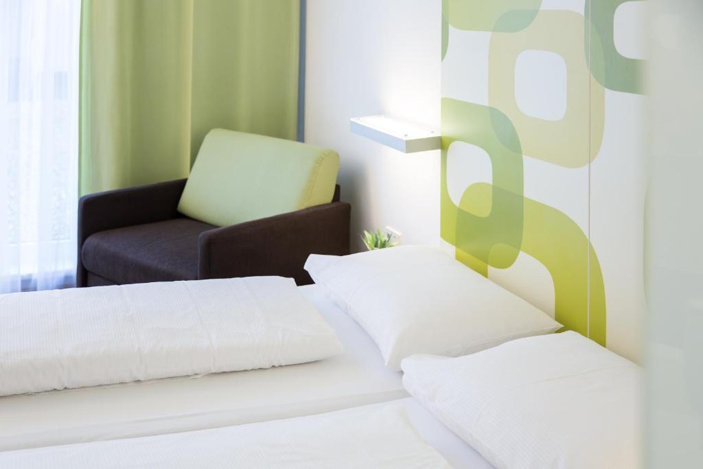 Posteľ alebo postele v izbe v ubytovaní arte Hotel Krems