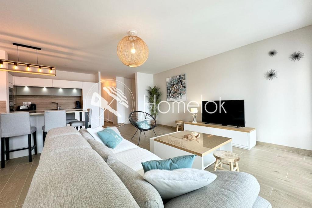 un salon avec un canapé et une table dans l'établissement T3 de standing Plein bourg - 100m des plages, à Saint-Pierre-Quiberon