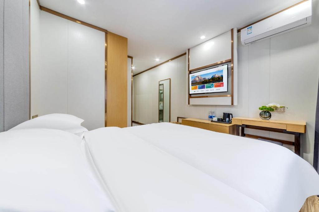 Postel nebo postele na pokoji v ubytování 泊汀酒店广州北京路步行街省中医店