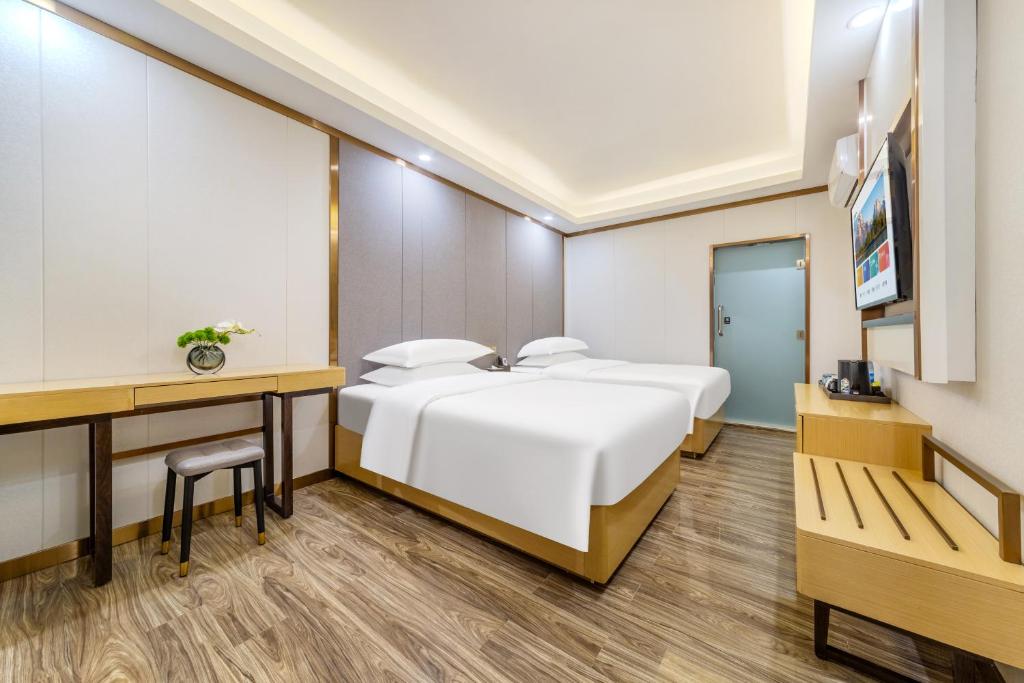Postel nebo postele na pokoji v ubytování 泊汀酒店广州北京路步行街省中医店