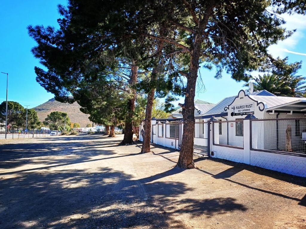 a street with trees in front of a building at Karoo Rust Victoria West in Victoria West