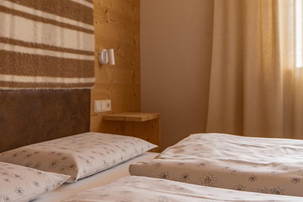 Posteľ alebo postele v izbe v ubytovaní Ciasa Iachin - Dolomites Dream Retreat