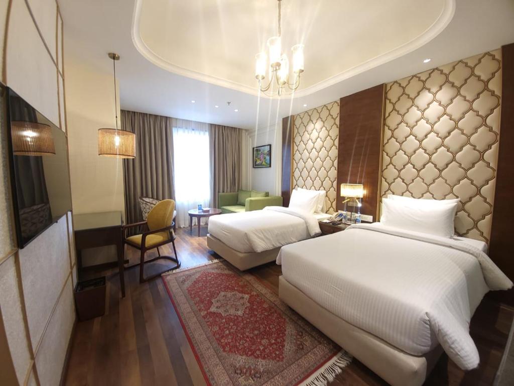 Postel nebo postele na pokoji v ubytování Sarovar Premiere Srinagar