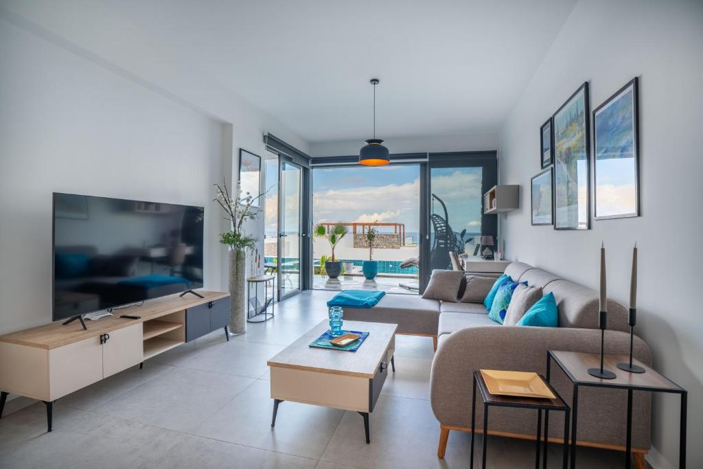 a living room with a couch and a table at Lighthouse Family Apartment with Private Pool in Kyrenia