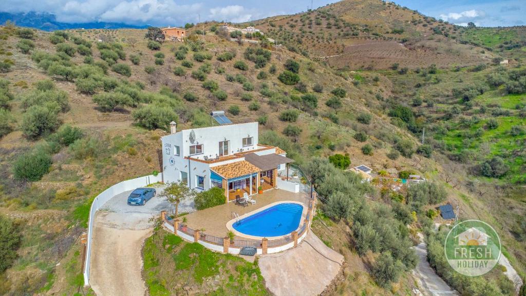 an aerial view of a house with a swimming pool at Casa de la Luz - lovely family villa in Arenas