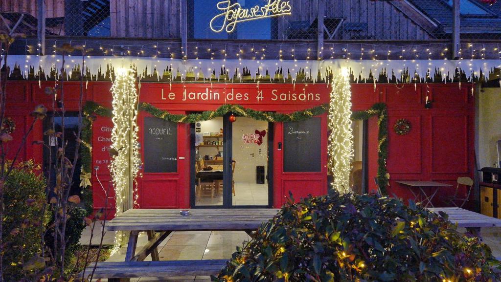 a restaurant with christmas lights in front of it at Le jardin des 4 saisons in Le Mans