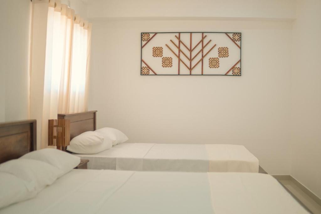 Letto o letti in una camera di R2 Guest - HIKKADUWA