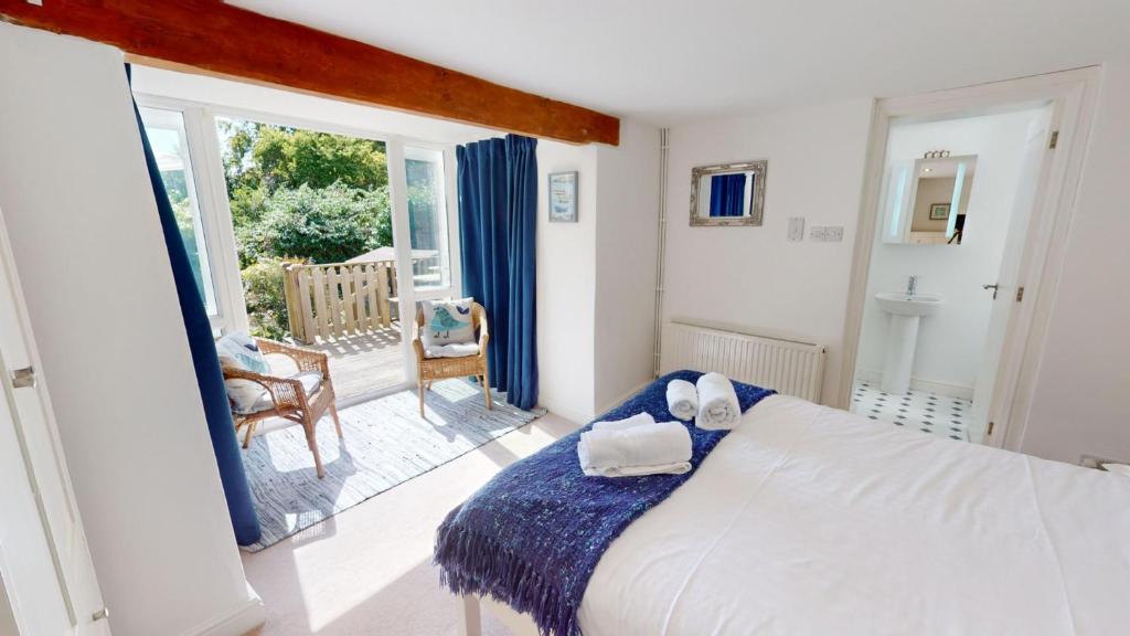 a bedroom with a bed and a large window at Georgeham Windsor Cottage 3 Bedrooms in Georgeham