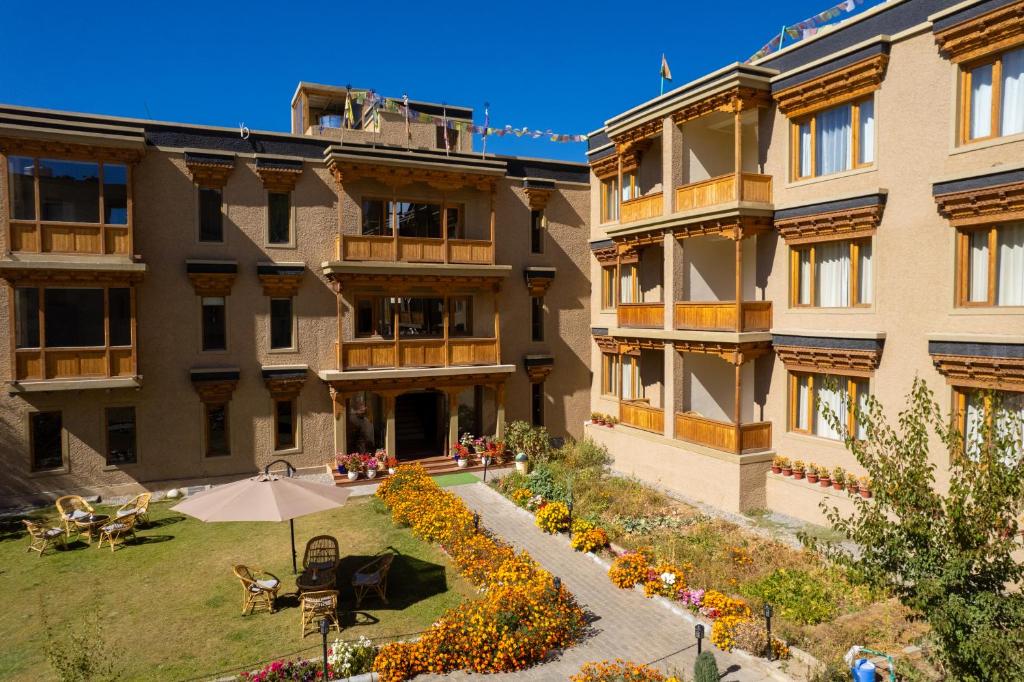 an apartment building with an umbrella and a courtyard at The Saraha in Leh