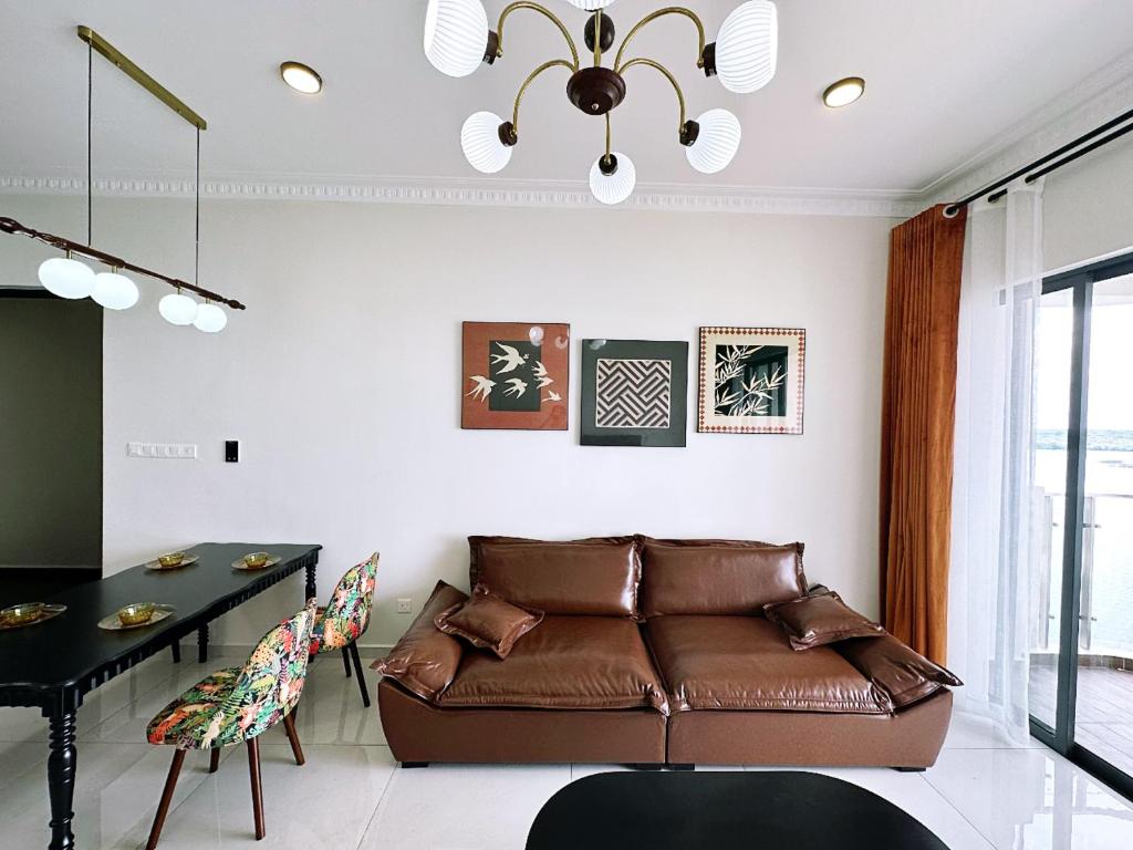 a living room with a couch and a table at Ocean View Family Suite in Johor Bahru
