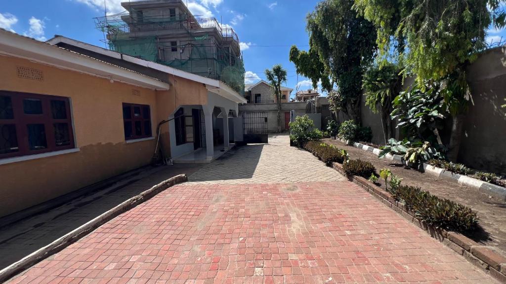 a brick walkway in front of a building at Amani House - Bed and Breakfast in Arusha