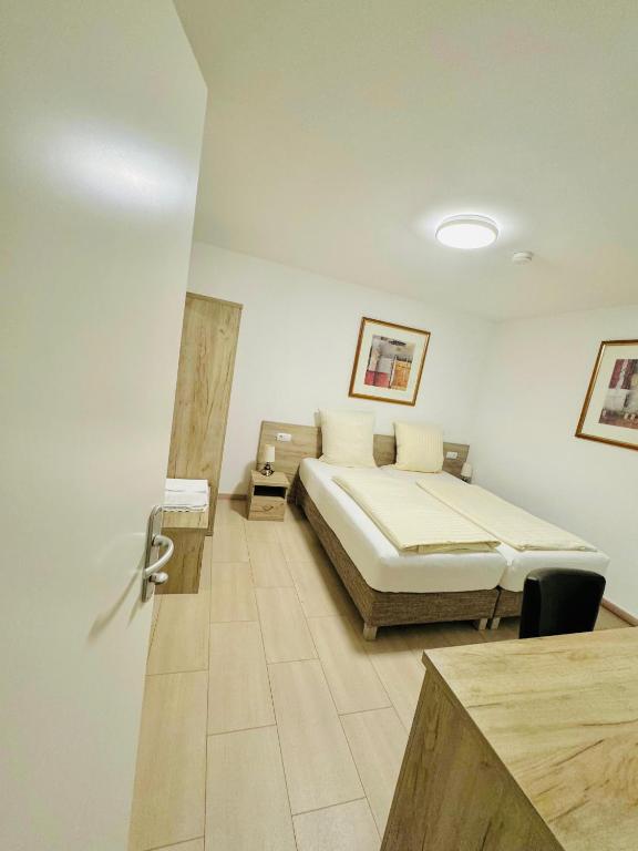 a bedroom with a bed in a room at Hotel Soad in Salach