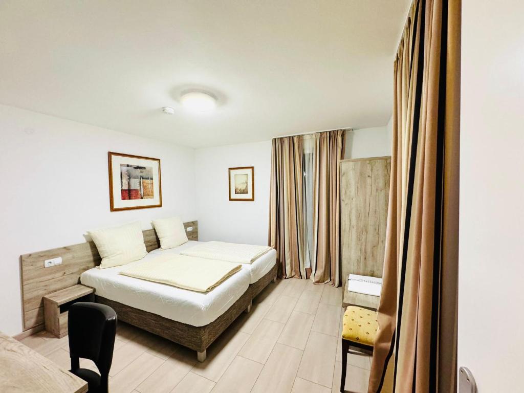 a hotel room with a bed and a window at Hotel Soad in Salach