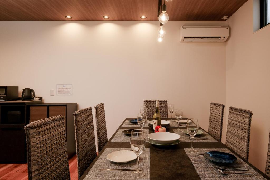 a dining room with a table with chairs and glasses at MIRATIO The Supreme in Onna