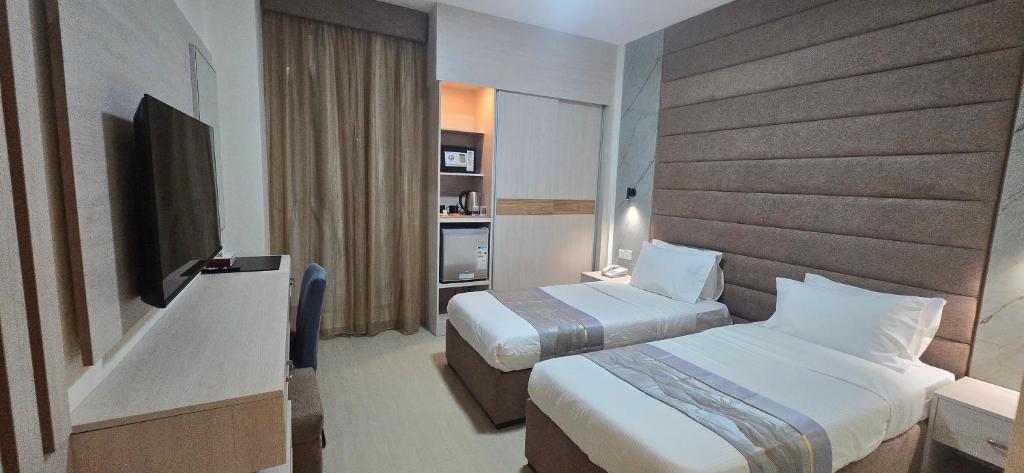 Postel nebo postele na pokoji v ubytování La Maison Hotel