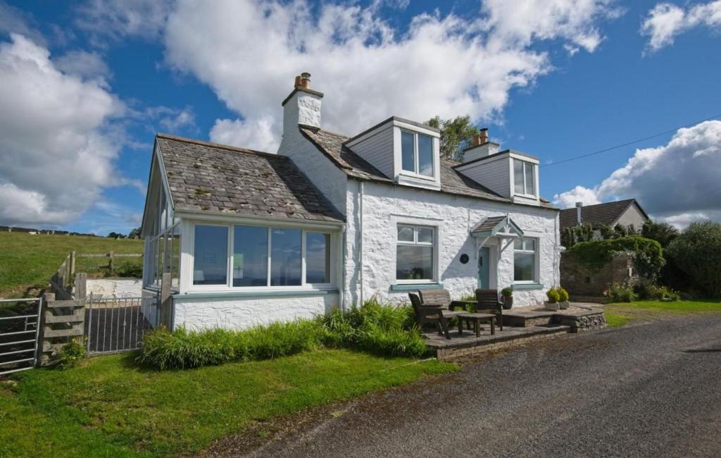 a white house on the side of a road at Bardristane Forge in Gatehouse of Fleet