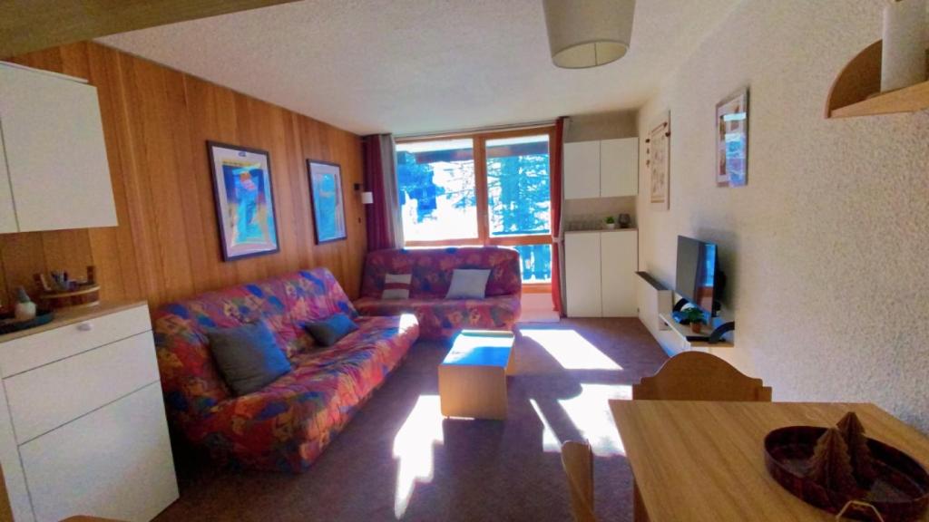 un salon avec un canapé et une télévision dans l'établissement Studio Isola 2000, à Isola 2000