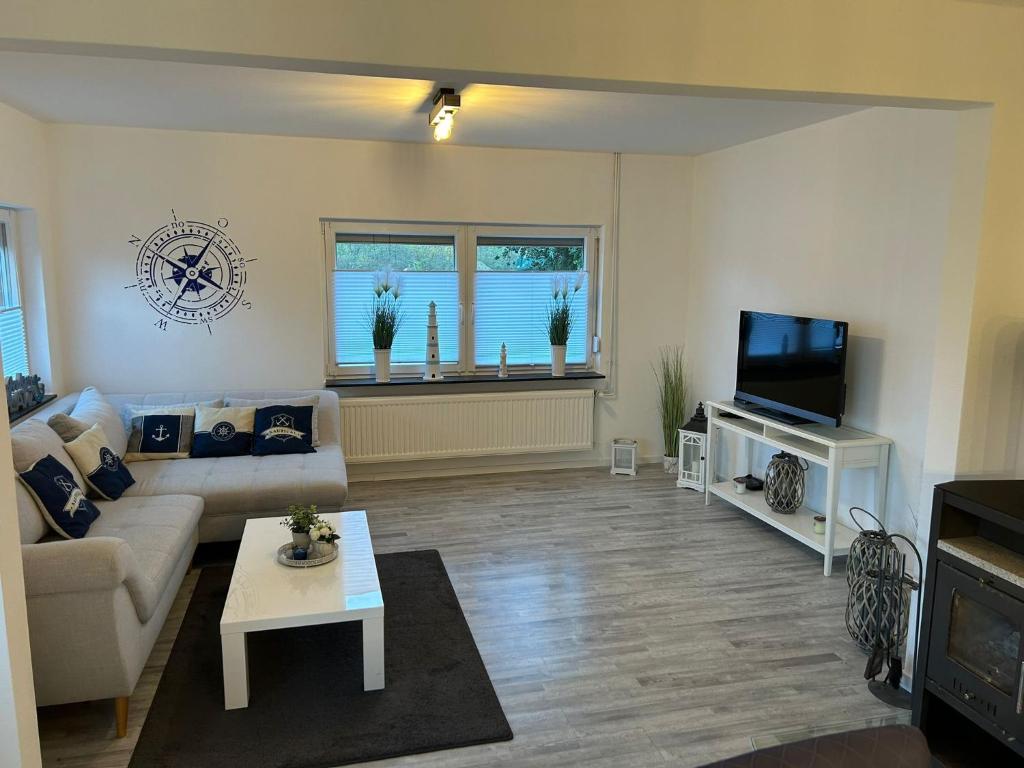 a living room with a couch and a tv at Hus Heideblick -zwischen Natur und Nordsee- in Sankt Michaelisdonn