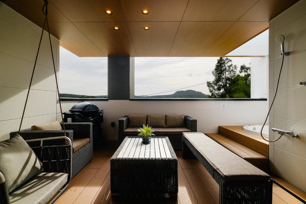 a room with couches and a table in a house at MIRATIO Sirius in Onna