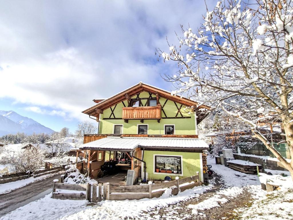 een huis in de sneeuw met een balkon bij Apartment Wiesenhof by Interhome in Reith bei Seefeld