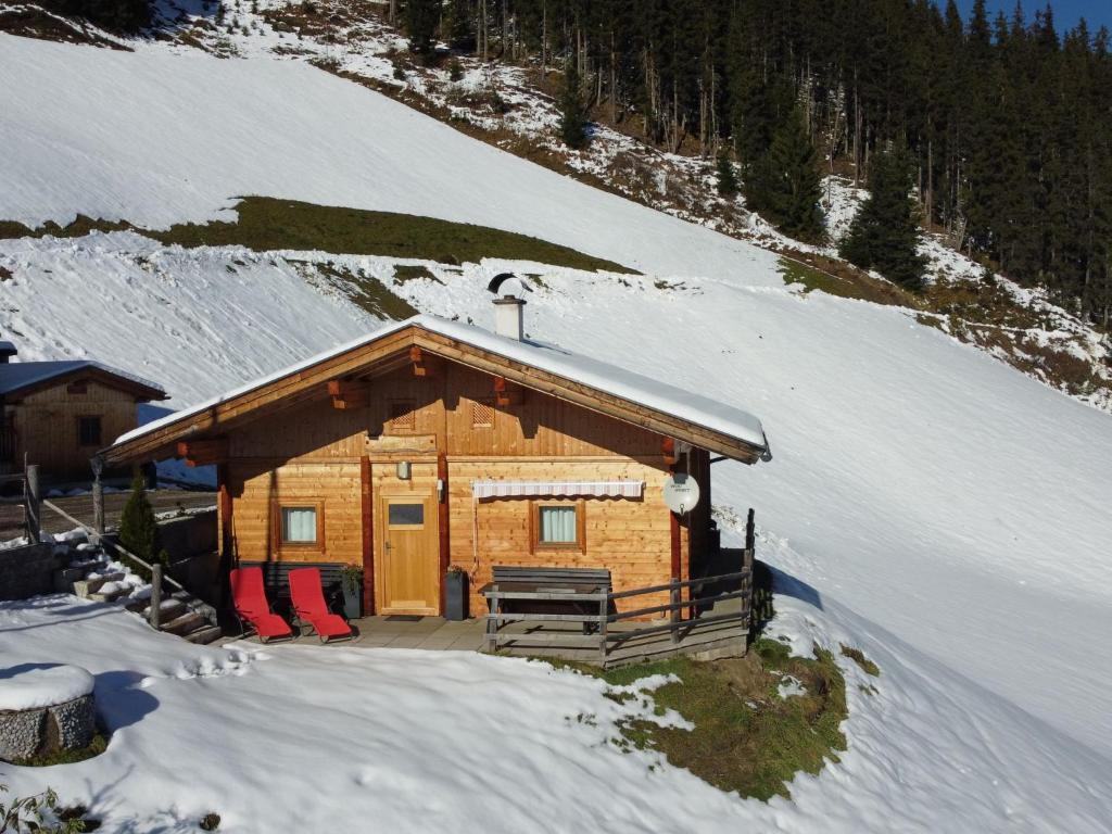 a log cabin in the snow on a mountain at Chalet Nasenalmhütte by Interhome in Hippach