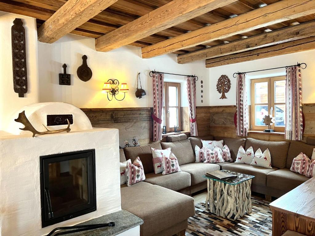 a living room with a couch and a tv at Holiday Home st martin chalets-2 by Interhome in Sankt Martin
