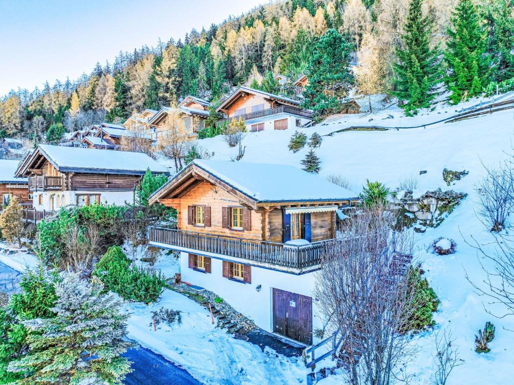 an aerial view of a log home in the snow at Chalet Chalet Soleil by Interhome in Nendaz