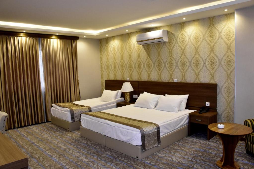 A bed or beds in a room at Erbil View Hotel