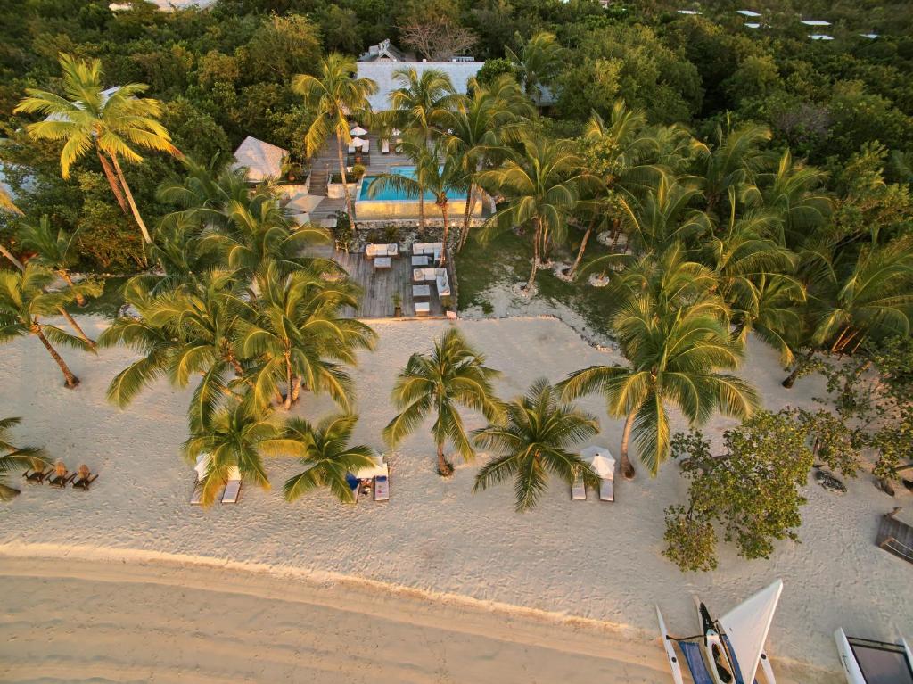 an aerial view of a beach with palm trees and a resort at Tiamo Resort in Congo Town