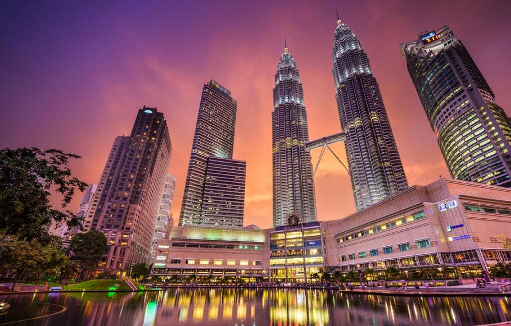a group of tall buildings in a city at night at Seri Bukit Ceylon Suites Bukit Bintang in Kuala Lumpur