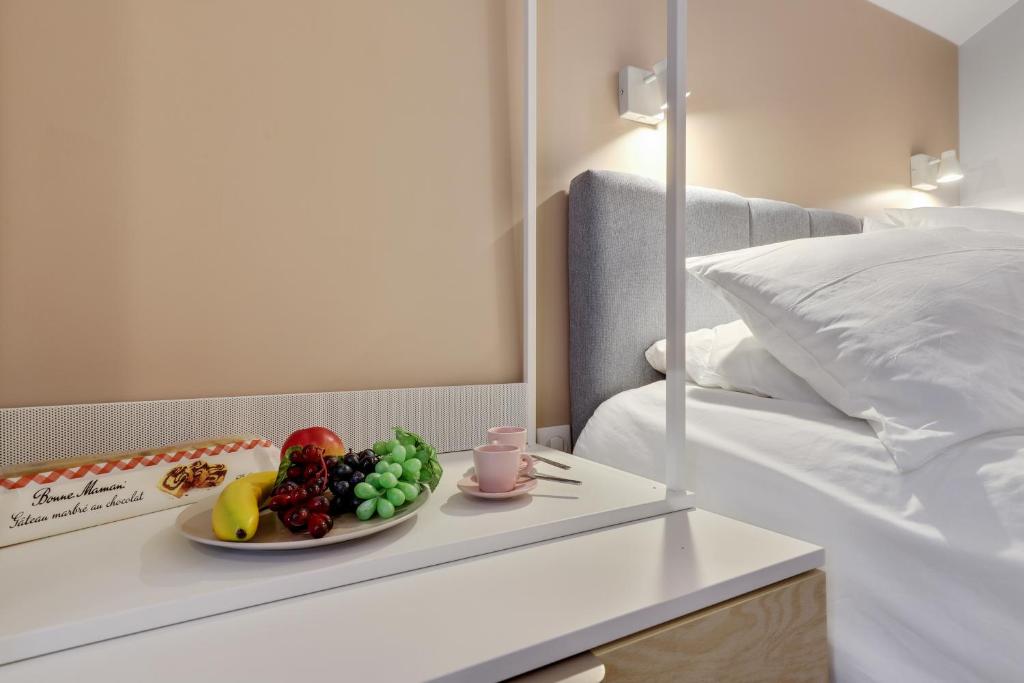 Postel nebo postele na pokoji v ubytování Lavie Maison face Palais Royal