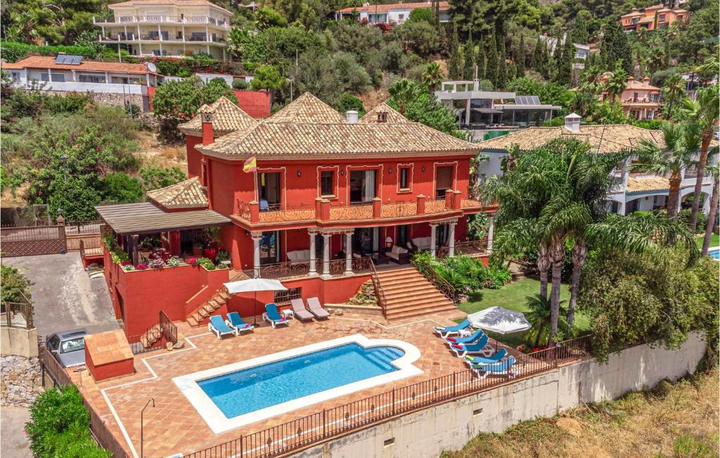 an aerial view of a house with a swimming pool at 6 Bedroom Awesome Home In Marbella in Marbella