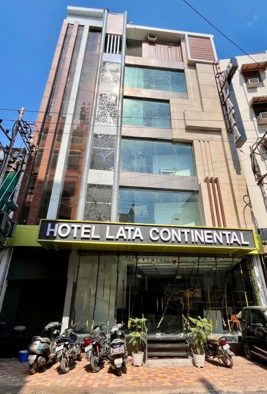 a hotel latina continental with motorcycles parked in front of it at Hotel Lata Continental in Kānpur