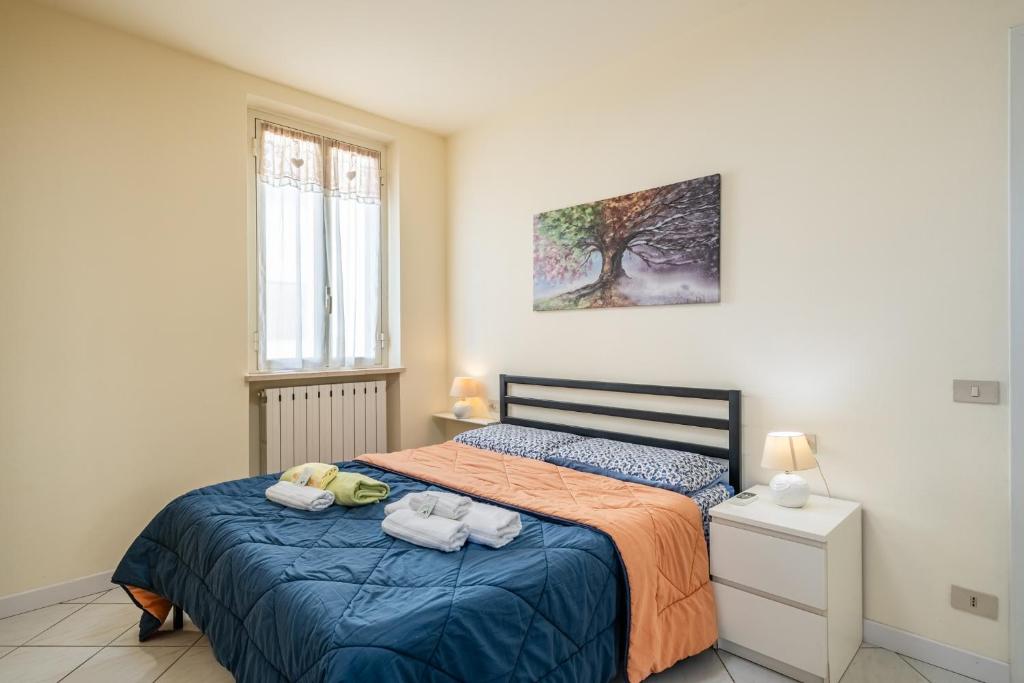 a bedroom with a bed with two towels on it at La Casina Gialla Independent House in Lucca