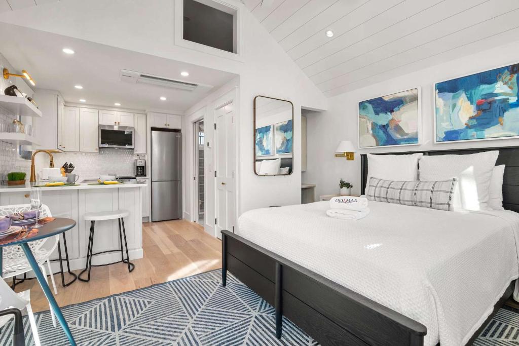 a bedroom with a large bed and a kitchen at Walk to Beach Shopping and Dining in Provincetown
