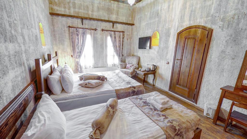 Postel nebo postele na pokoji v ubytování Hikmet's House