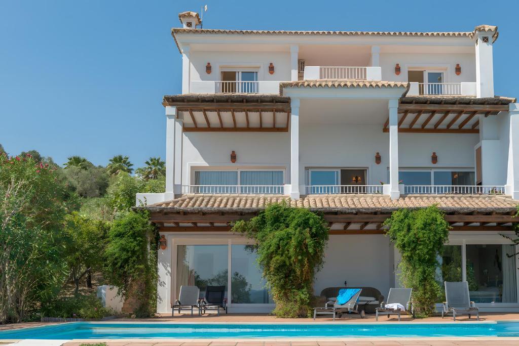 a large white building with a swimming pool in front of it at Villa Índigo in Benalup Casas Viejas