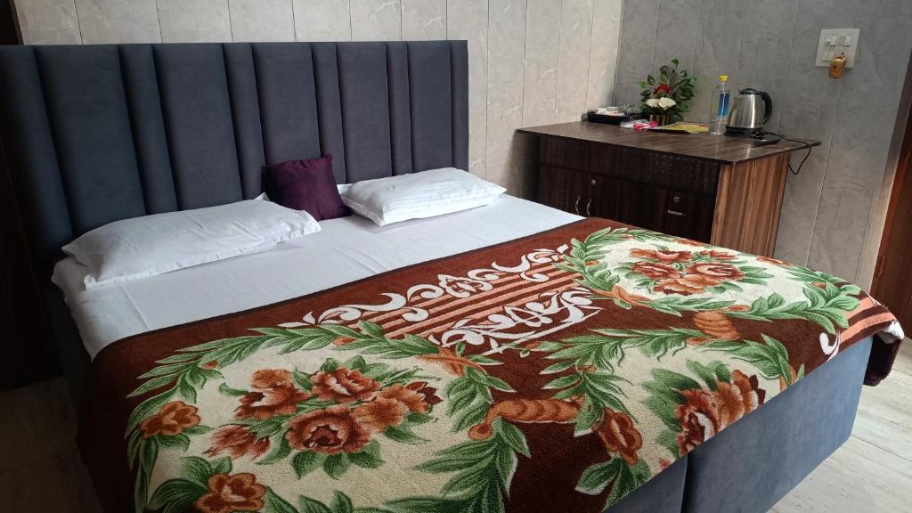 a bedroom with a bed with a floral blanket at Australia villa fully Ac Fridge Tv Wifi in Bathinda
