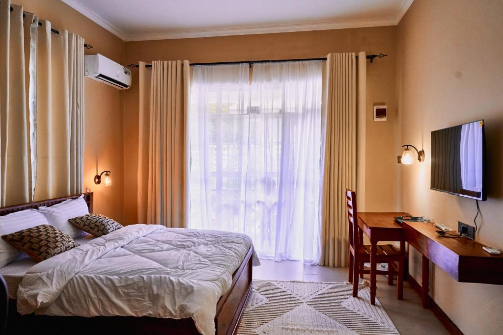 Ένα ή περισσότερα κρεβάτια σε δωμάτιο στο Birds of Paradise Homes 2