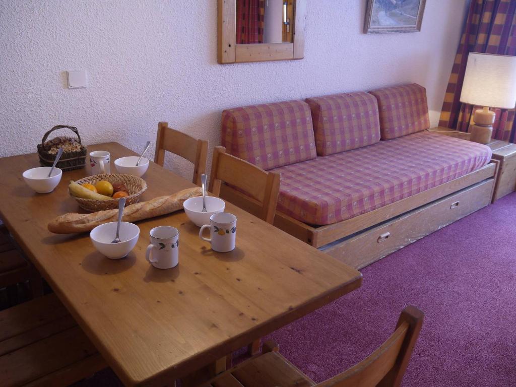 un salon avec une table et un canapé dans l'établissement Charmant appartement à Méribel avec balcon et accès direct aux pistes - FR-1-355-36, à Méribel