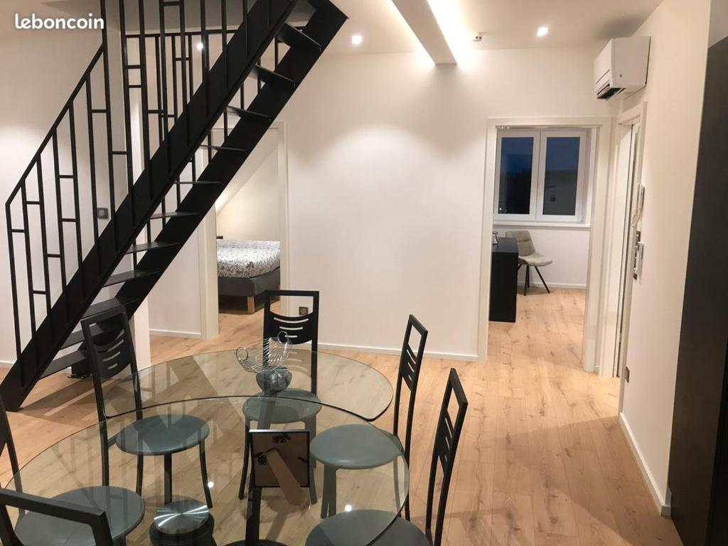 une salle à manger avec une table et des chaises en verre dans l'établissement Gîte de la Chapelle - Le Bi jou, à Innenheim