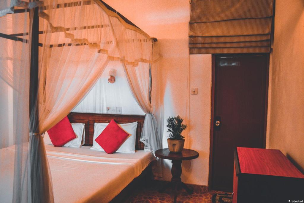 Postel nebo postele na pokoji v ubytování Kapila Gusethouse in Unawatuna
