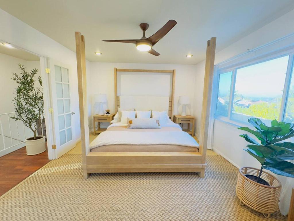 a bedroom with a bed and a ceiling fan at Del Mar Coastal Haven in San Diego