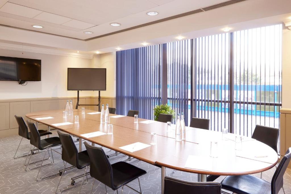a large conference room with a large table and chairs at Stamford Bridge Hotel London in London
