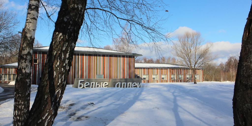 a building with a sign that reads beale mill in the snow at The White Alleys Holiday Park in Voronovo