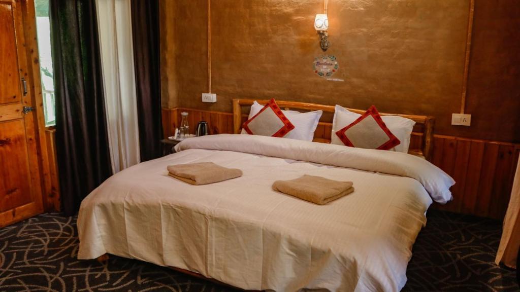 Postel nebo postele na pokoji v ubytování Mudhostel