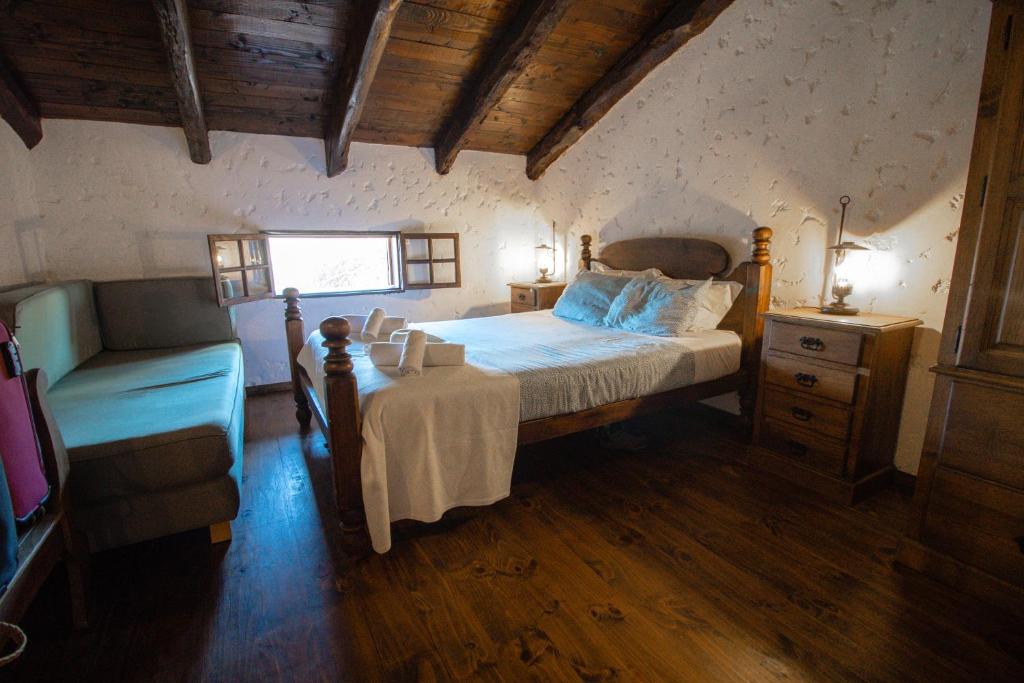 a bedroom with a large bed and a window at Alojamento Casas da Serra in Porto Santo