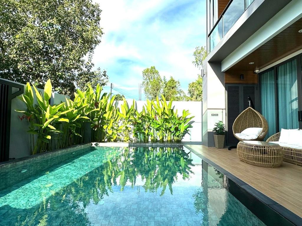 a swimming pool in the backyard of a house at Stay Tuned Pool Villa in Pattaya in Ban Huai Yai