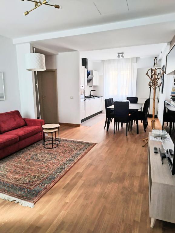 a living room with a red couch and a table at VM Ravenna Luxury Apartment in Ravenna